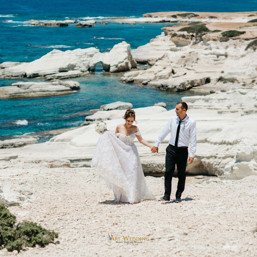 Wedding photo walk on white rocks by the sea