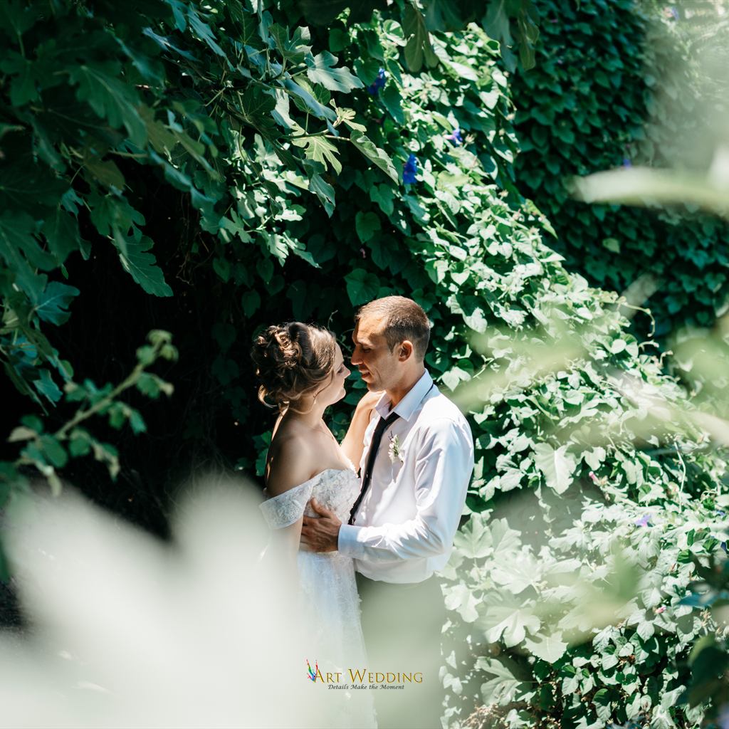 Newlyweds surrounded by greenery at Peyia Gardens