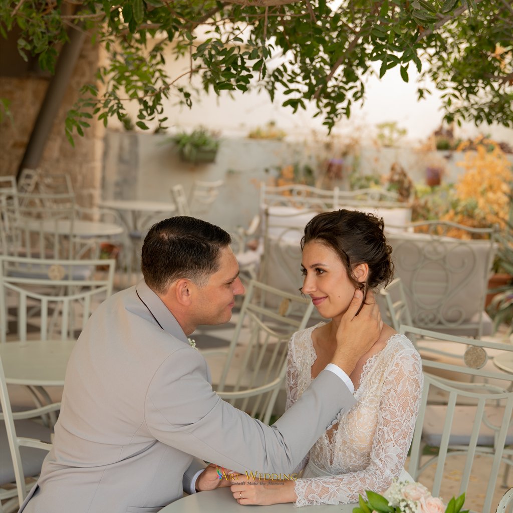 A tender moment in a leafy café during the wedding photo walk