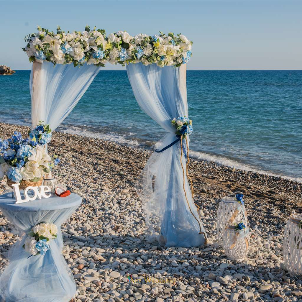 Blue and white wedding arch decorations on the beach
