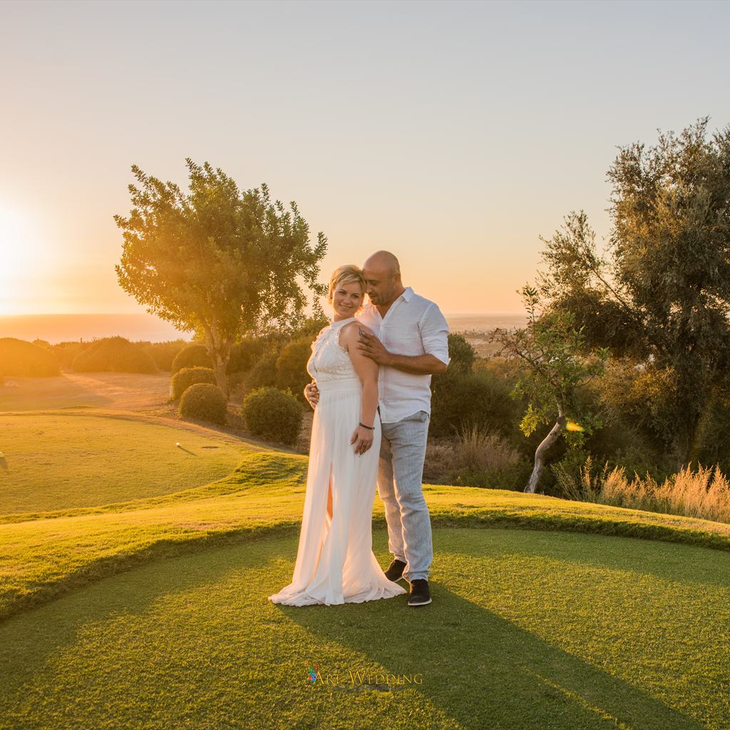 Wedding photo walk on a green lawn at sunset