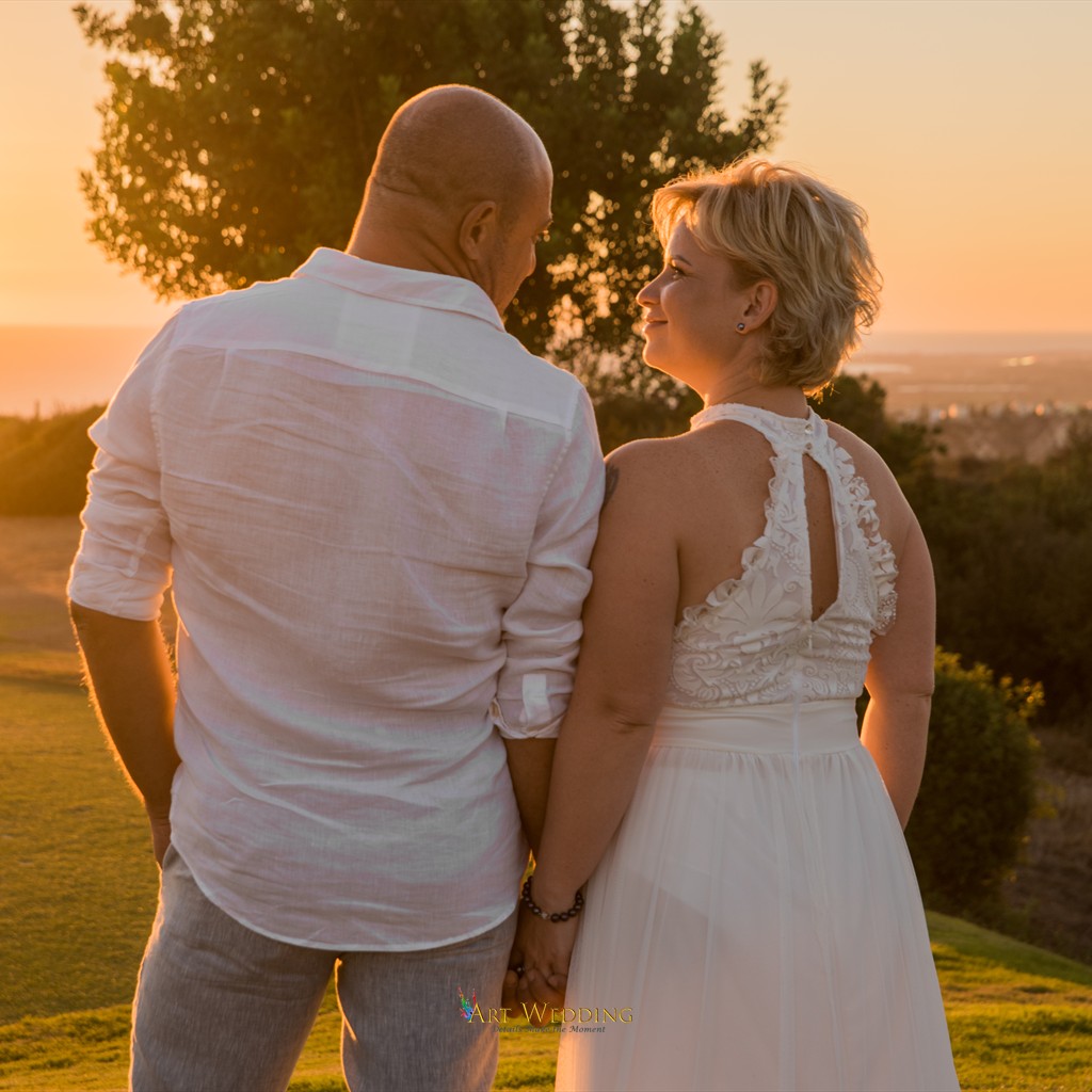 Newlyweds looking at each other in the sunset light