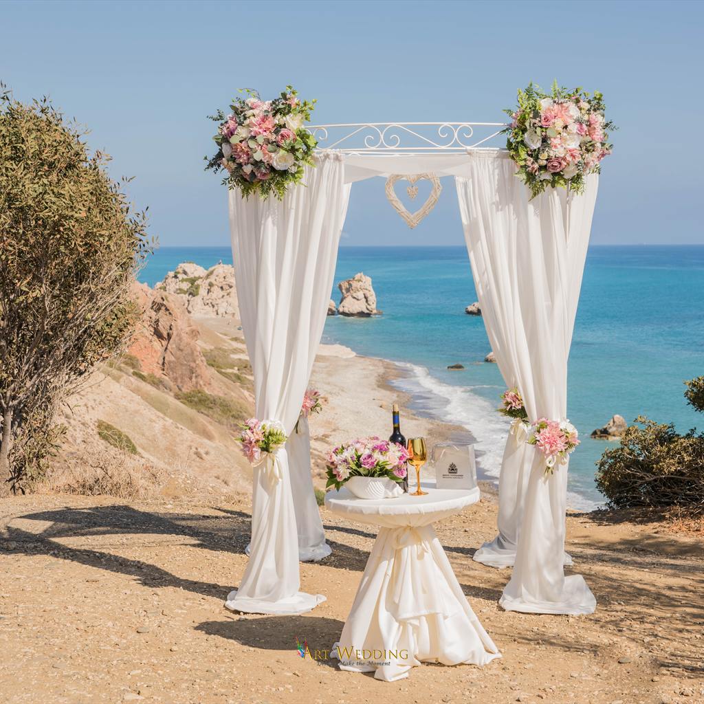 White wedding arch overlooking the Petra tou Romiou coastline