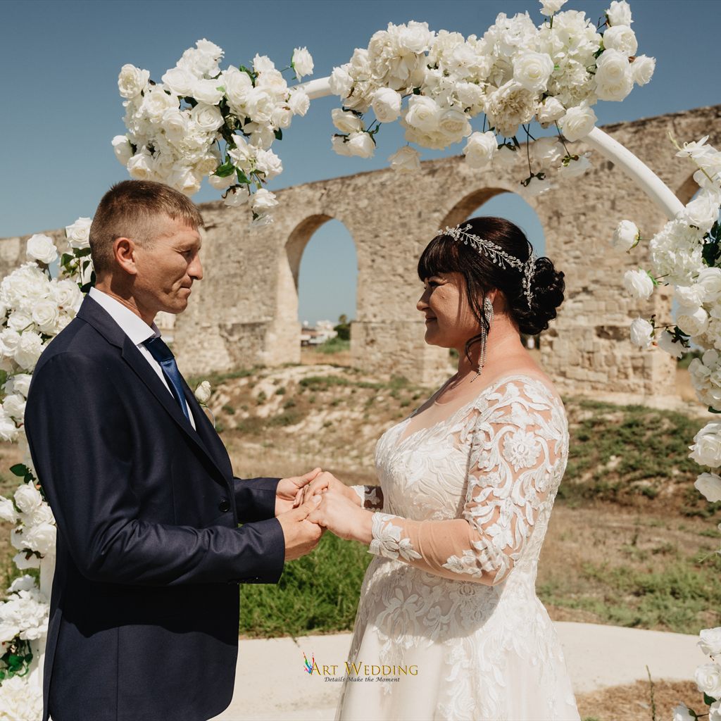 Bride and groom holding hands during their ceremony