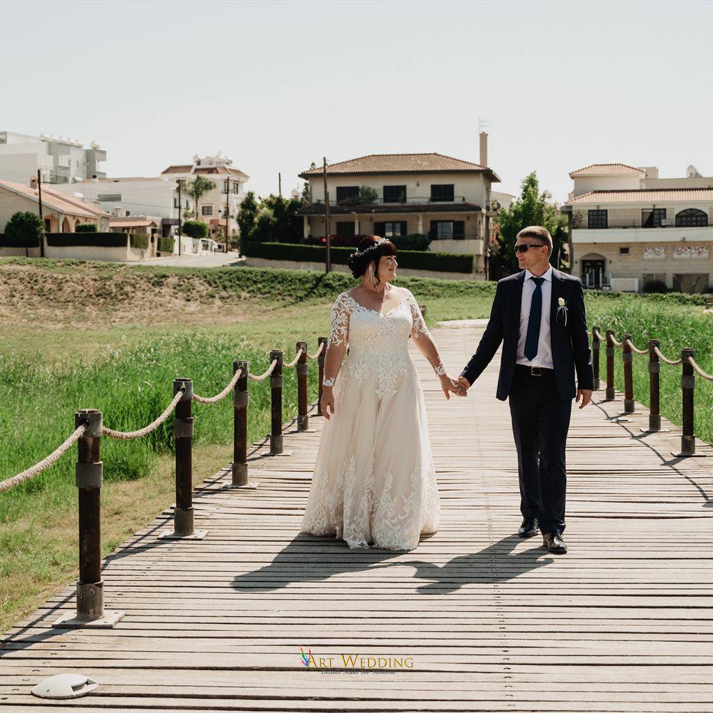Wedding walk along a wooden boardwalk in Larnaca