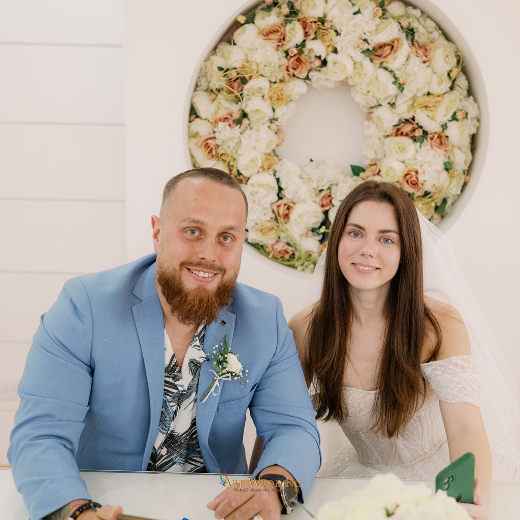 Newlyweds seated at the registration table in Aradippou
