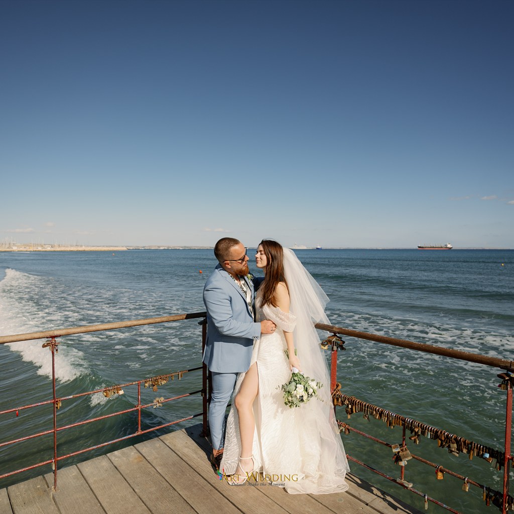 Wedding couple on a pier overlooking the sea