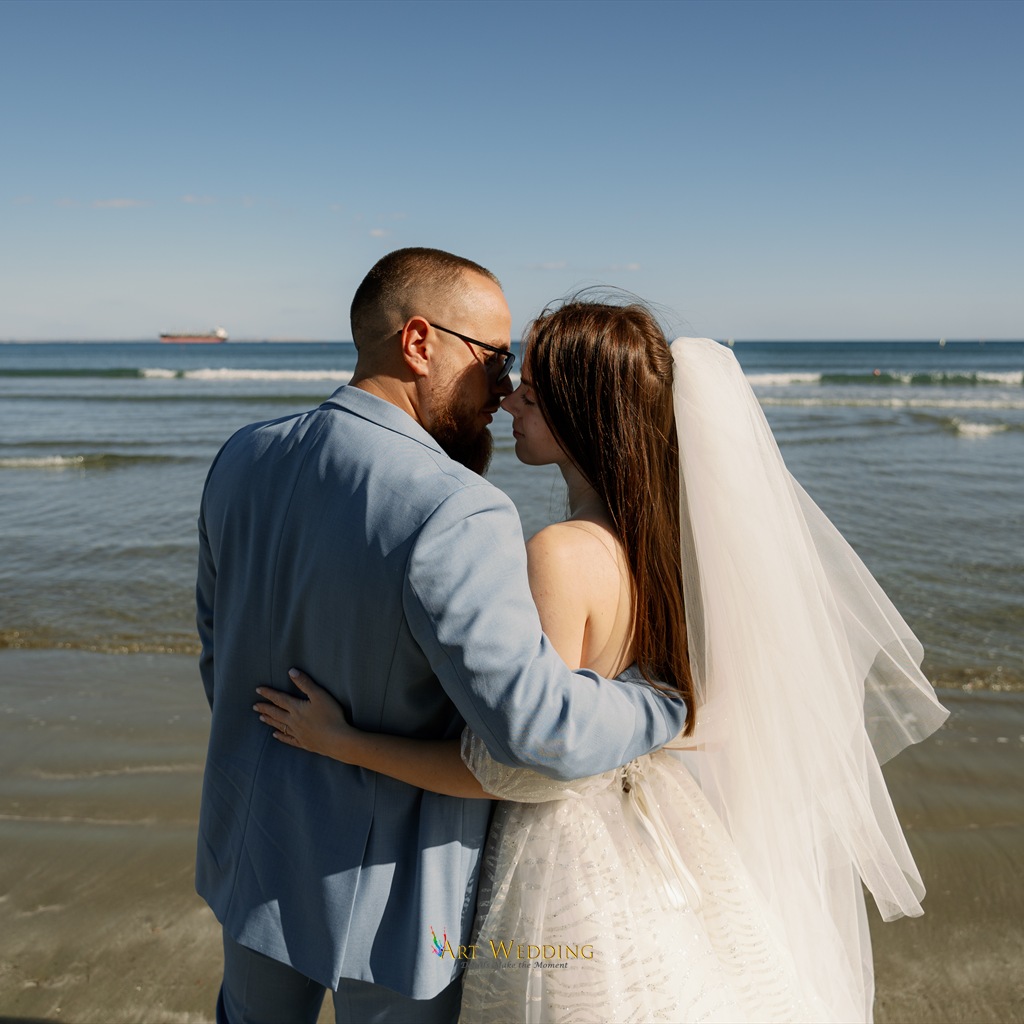 Newlyweds embracing on the seashore