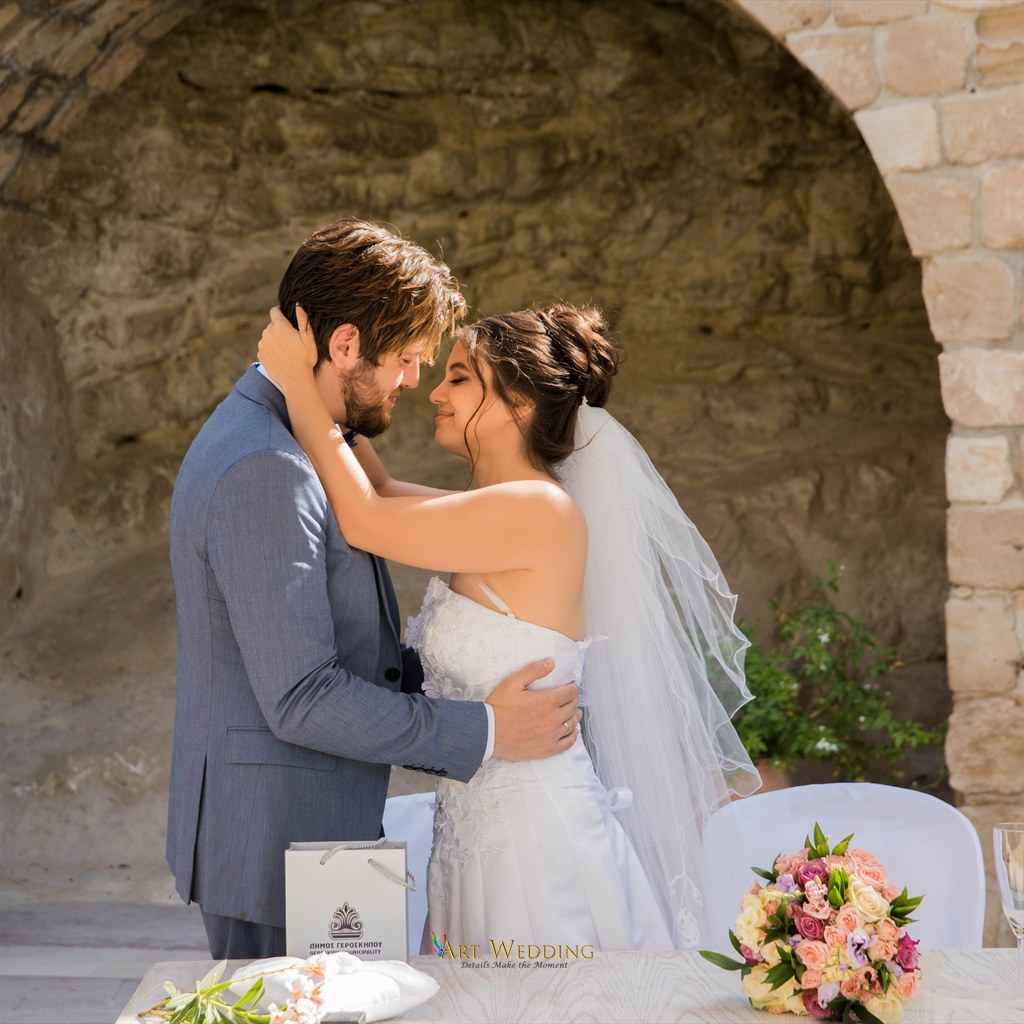 Couple embracing by the ceremony table