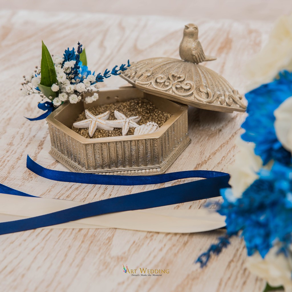 Wedding details with seashells and blue ribbons