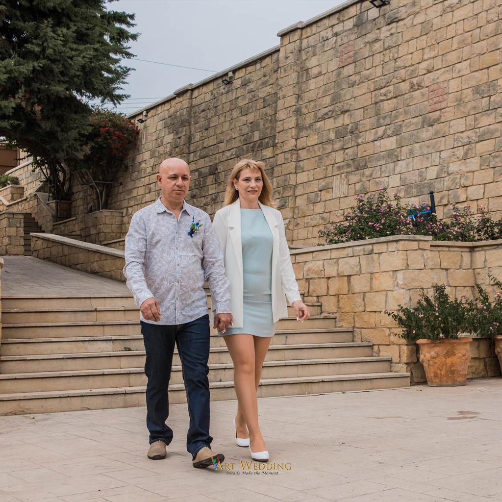 Newlyweds walking down stone steps
