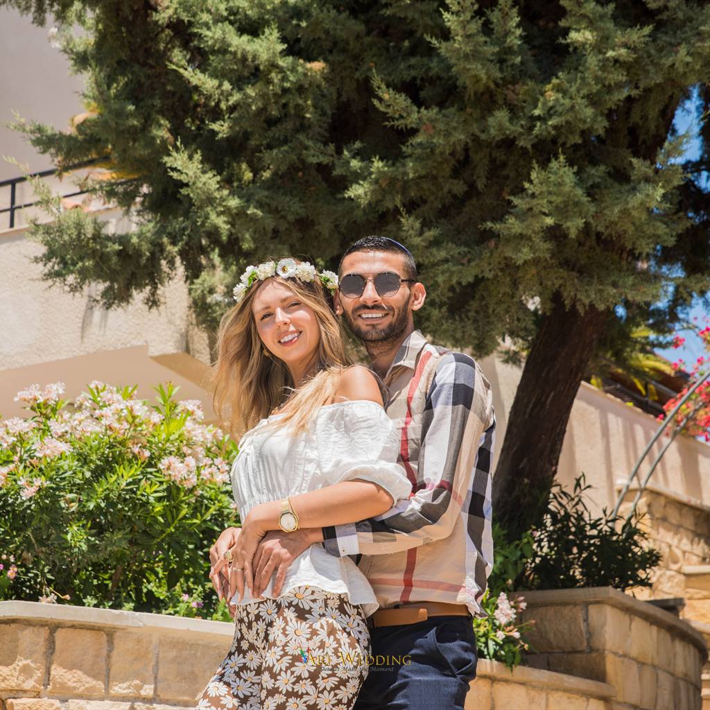 Couple portrait among flowers and greenery