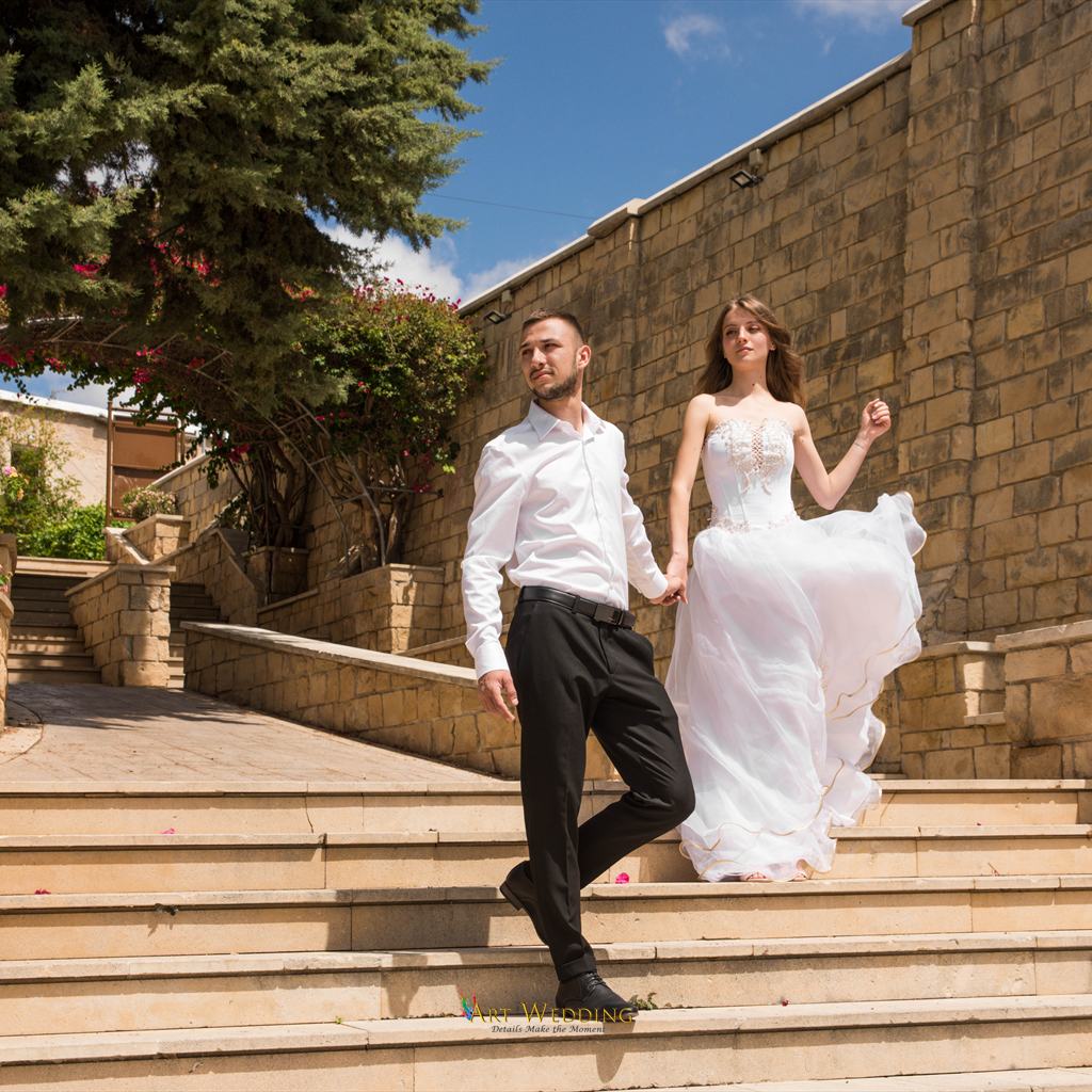 Newlyweds on the stone steps at Aphrodite Gardens
