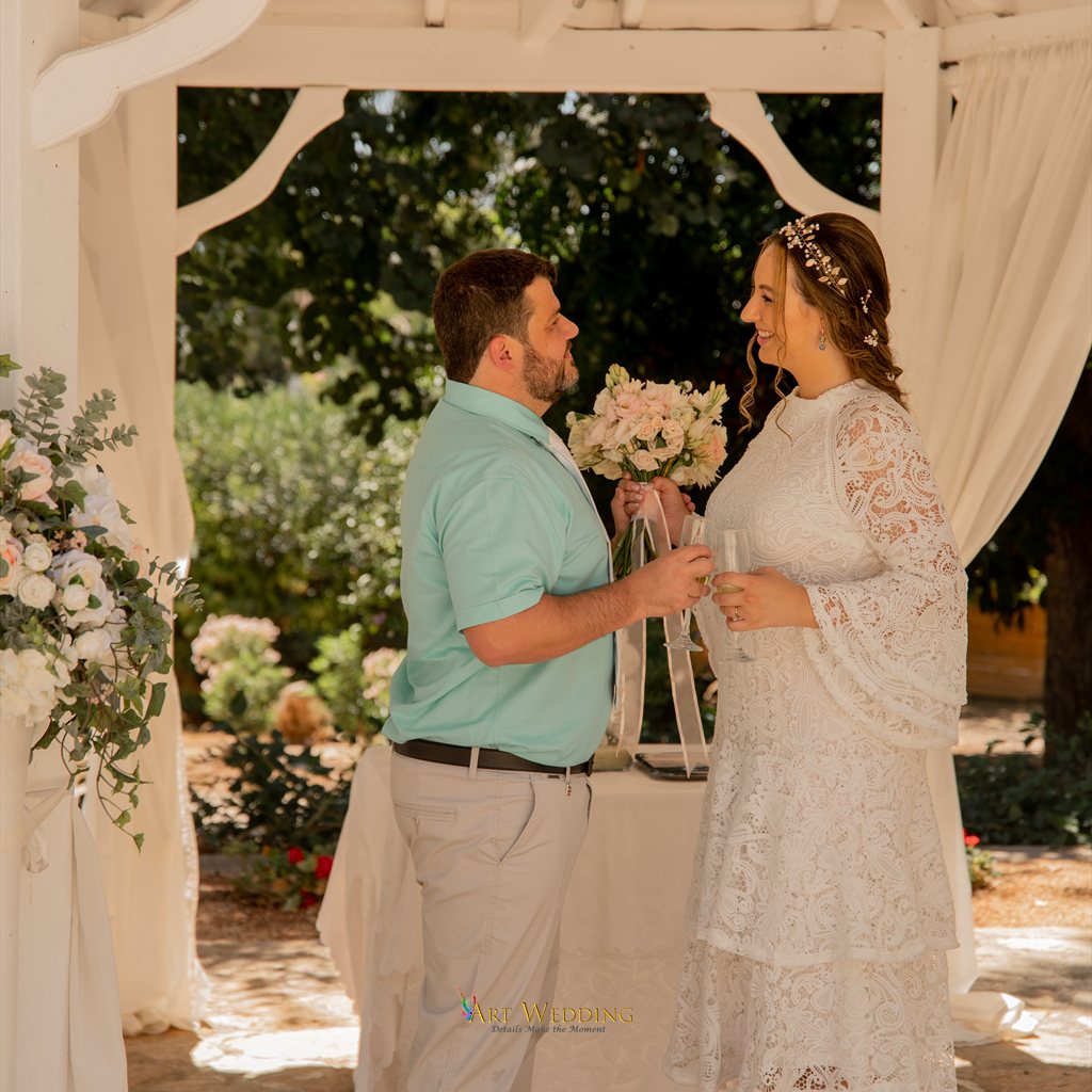 Wedding at Peyia Gardens — newlyweds toasting in the gazebo