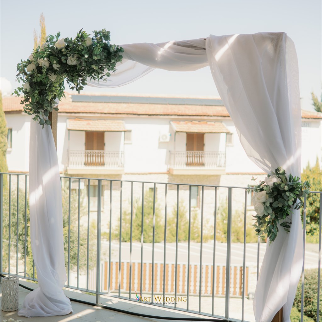 White floral arch for a terrace ceremony — Lefkara, Cyprus
