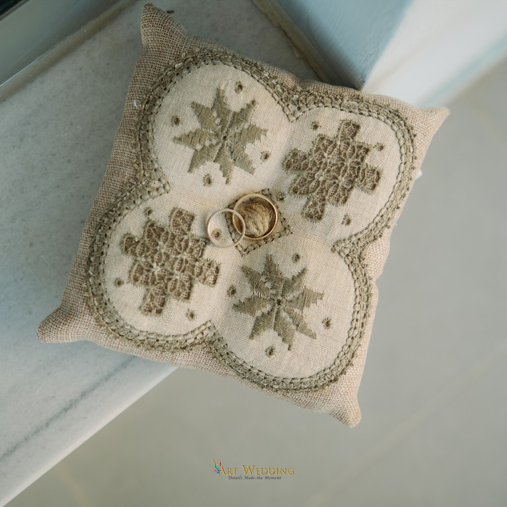 Wedding rings on an embroidered cushion — Lefkara, Cyprus