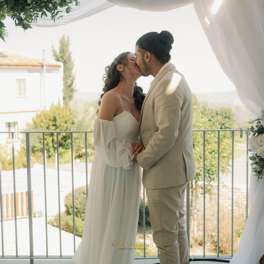 Wedding kiss beneath the terrace arch — Lefkara, Cyprus