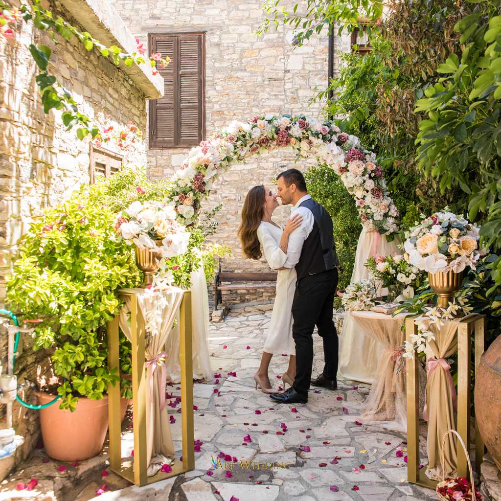 Wedding kiss in a decorated stone courtyard — Lefkara, Cyprus