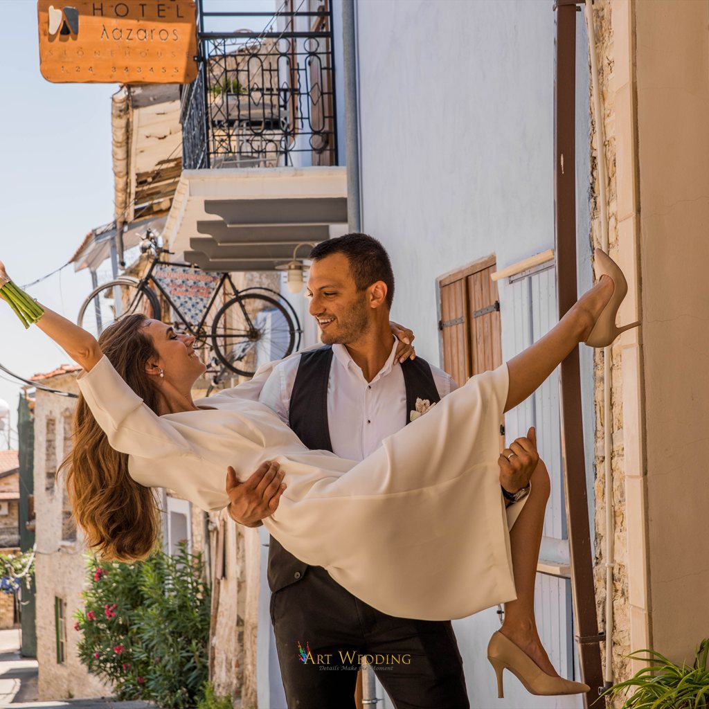 Groom holding the laughing bride in his arms — Lefkara, Cyprus