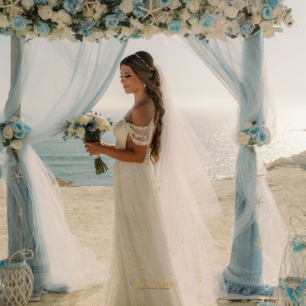 Bridal portrait with a bouquet beneath a blue arch
