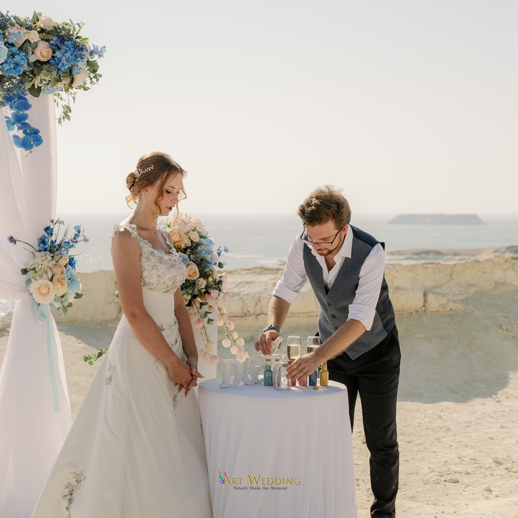 Sand ceremony beside the wedding arch