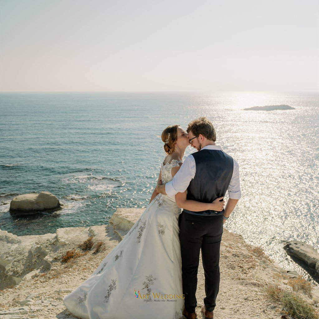 Tender wedding portrait on white rocks by the sea