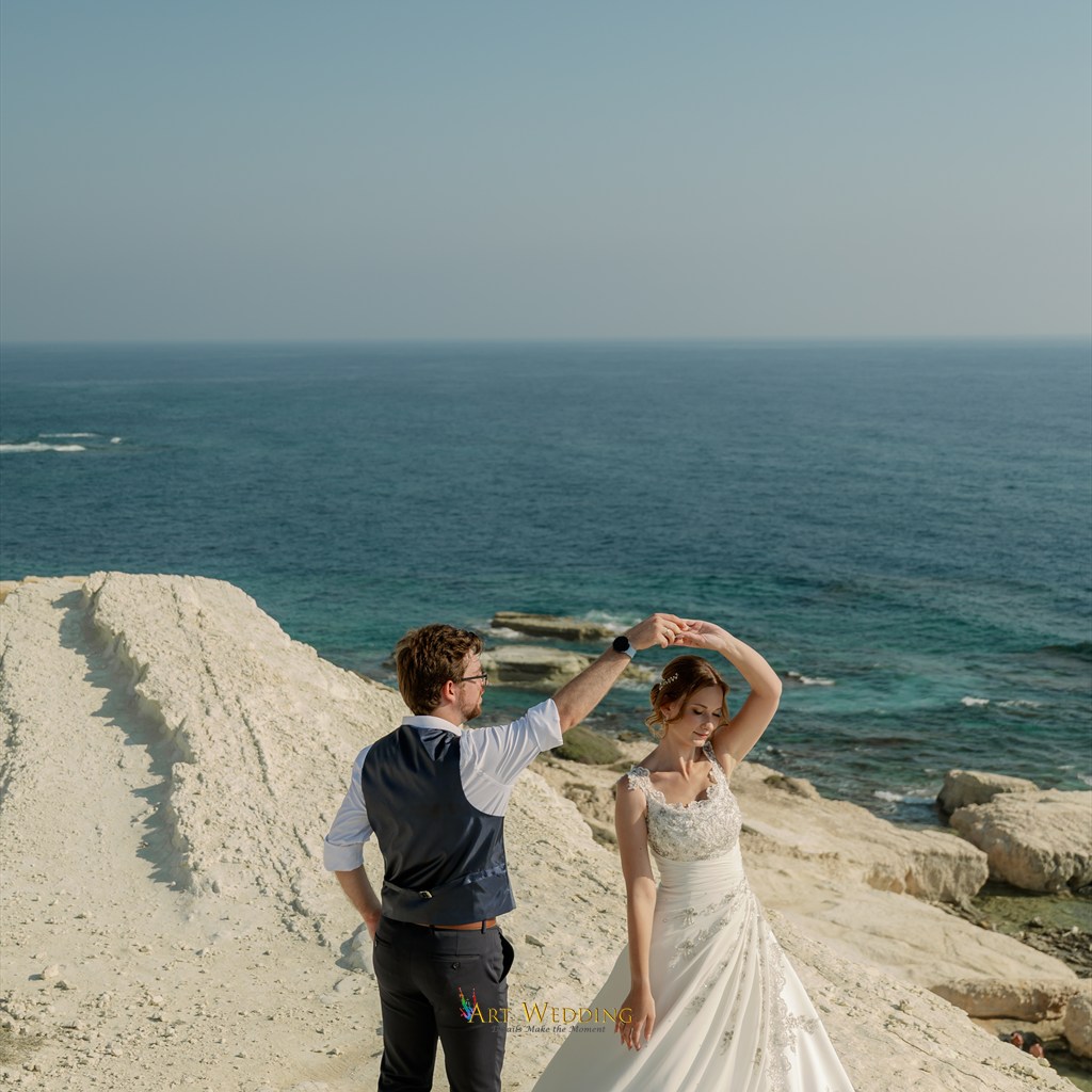 Wedding dance on white rocks beside the sea
