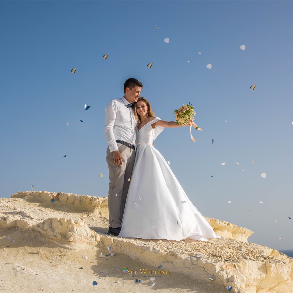 Wedding petals against the sea and white cliffs