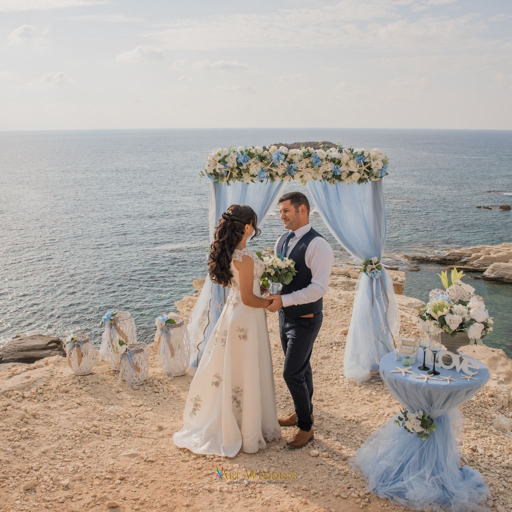 Couple beneath a floral arch at the White Cliffs of Peyia