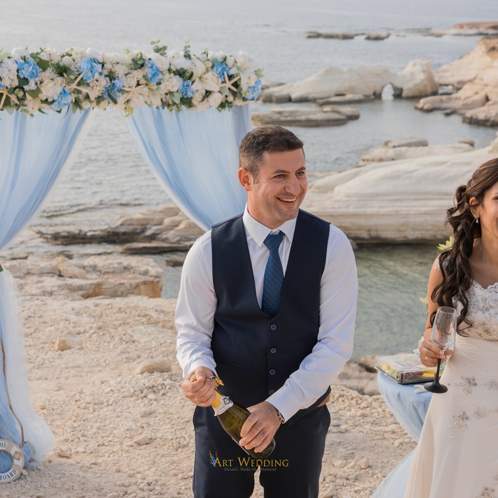 First wedding toast beside the floral arch