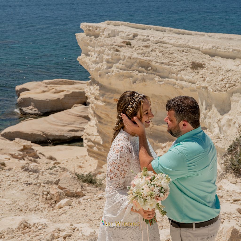 Tender wedding portrait on white rocks by the sea